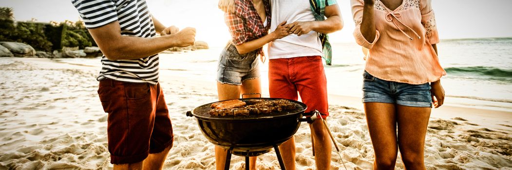 Friends having a barbecue at the beach