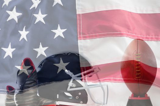 Close up of sports shoes and helmet by American football on tee against full frame of american flag