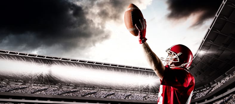 American football player standing with helmet and rugby ball against composite image of sport arena with supporter