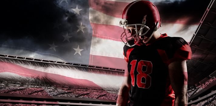 American football player standing in helmet against close-up of an american flag