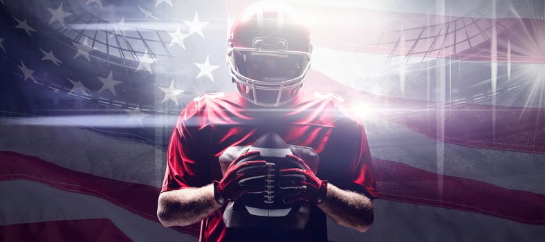 American football player standing with rugby helmet and ball against close-up of an american flag