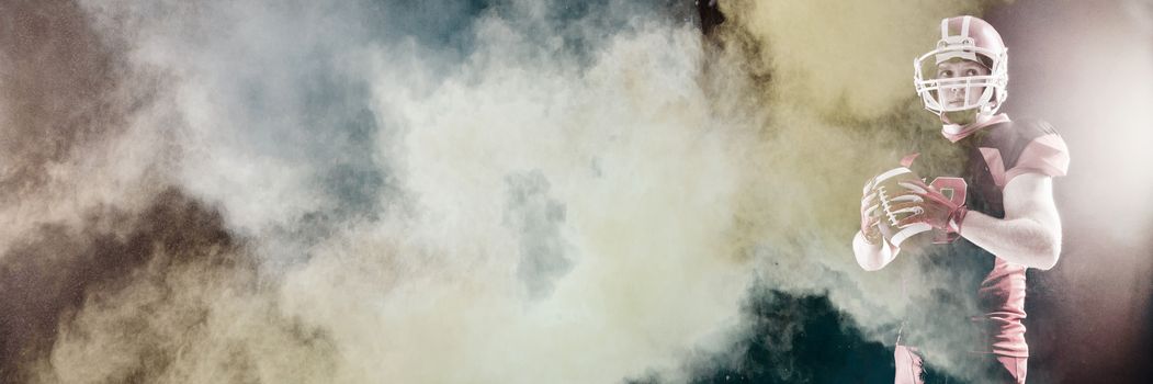 Splashing of powder against american football player in helmet holding rugby ball