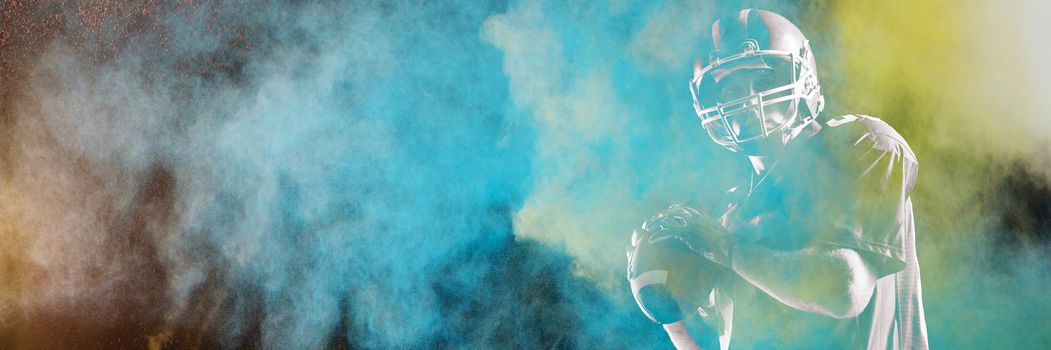 Dust powder against white background against american football player holding rugby ball