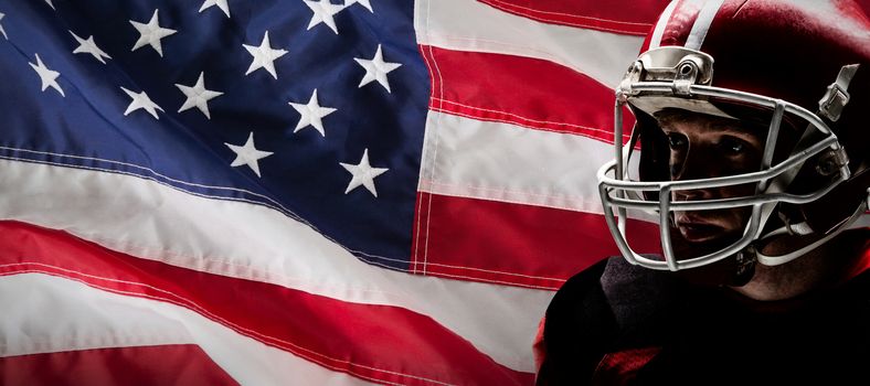 American football player standing in rugby helmet against close-up of an american flag