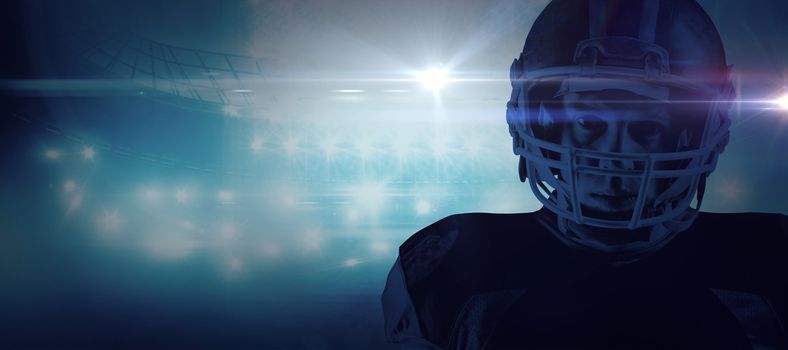 American football player standing in helmet against american football arena