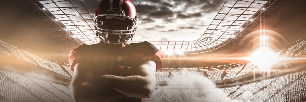 Young American football player standing with arms crossed