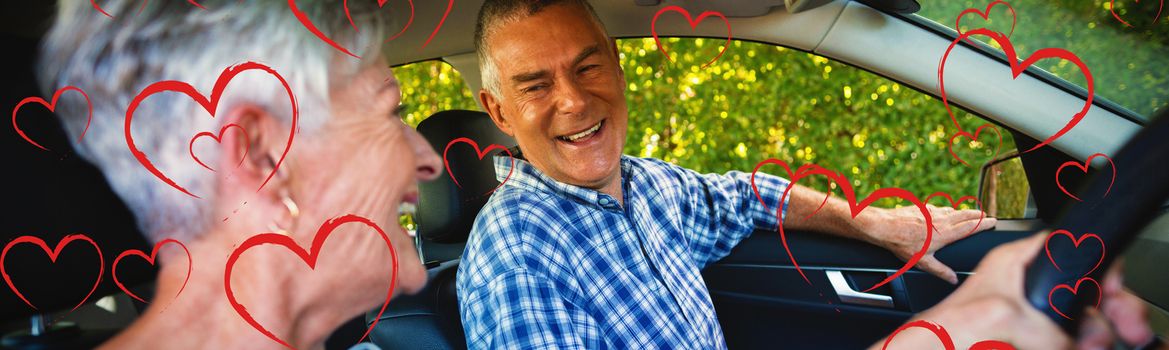 Red Hearts against senior couple sitting in car