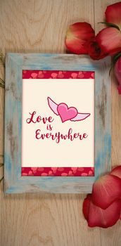 Cute Valentines Day message in Frame on desk with gifts and petals
