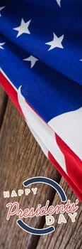 Happy presidents day. Vector typography against american flag on a wooden table