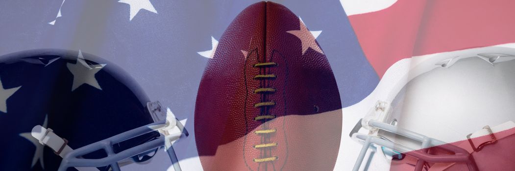 Close up of brown American football on tee by sports helmets against full frame shot of national flag