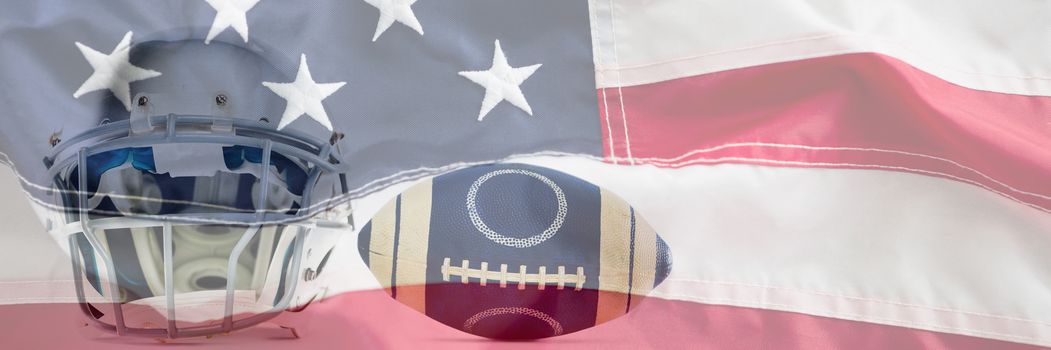 Sports helmet and American football against full frame of american flag