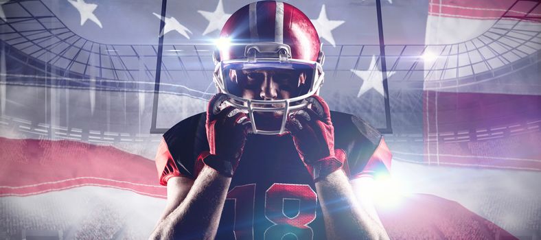 American football player standing with rugby helmet against close-up of an american flag