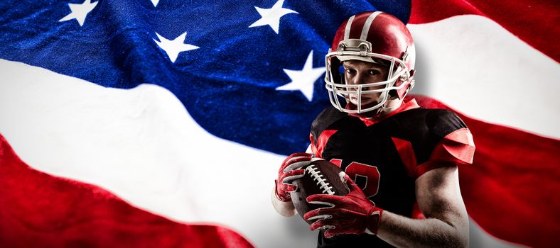 American football player in helmet holding rugby ball against american flag with stars and stripes