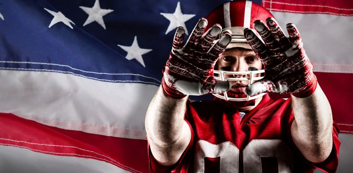 American football player gesturing against close-up of an american flag