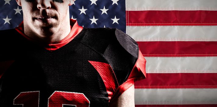 American football player standing against american national flag with stars and stripes