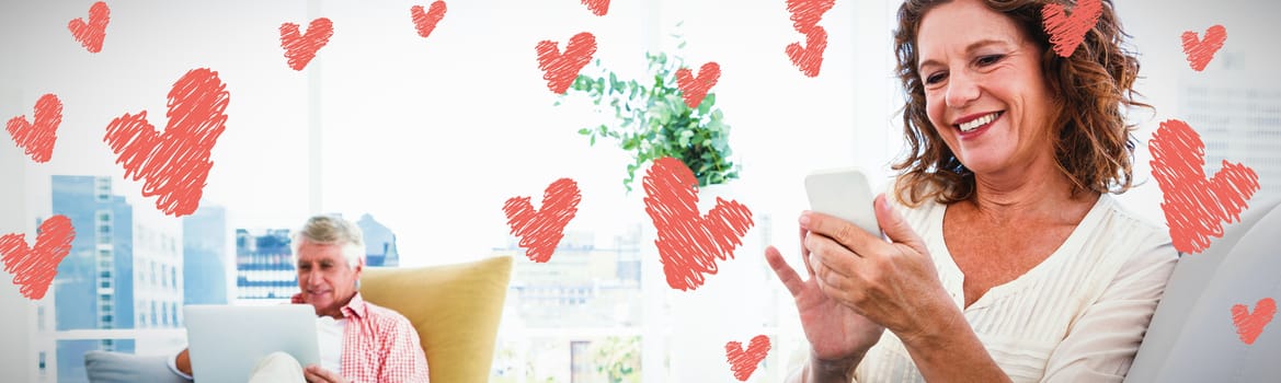 Red Hearts against smiling woman using smartphone by man sitting at home
