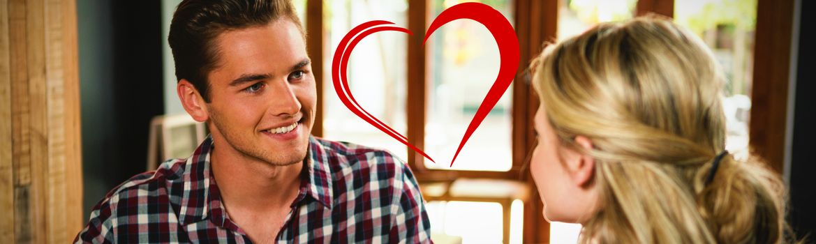 Heart against man having coffee while talking with woman in cafe
