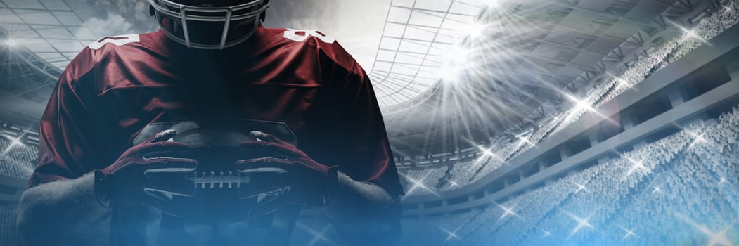 Young American football player standing in rugby helmet and holding rugby ball