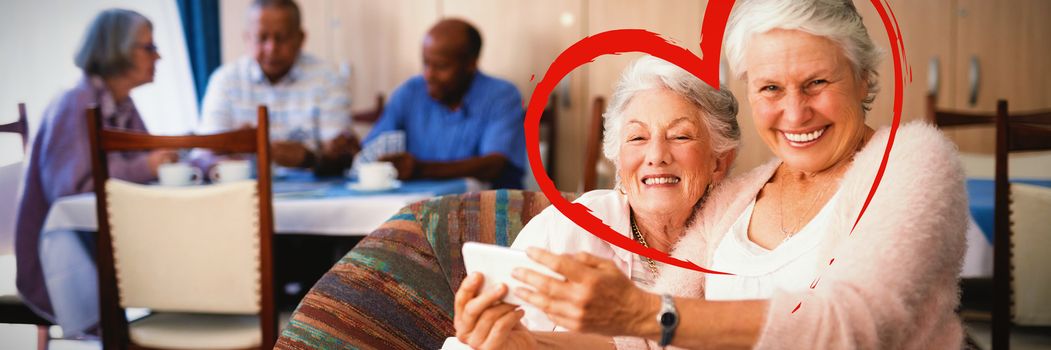 Heart against portrait of smiling senior woman taking selfie with friend
