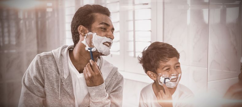 Father and son shaving together in the bathroom at home