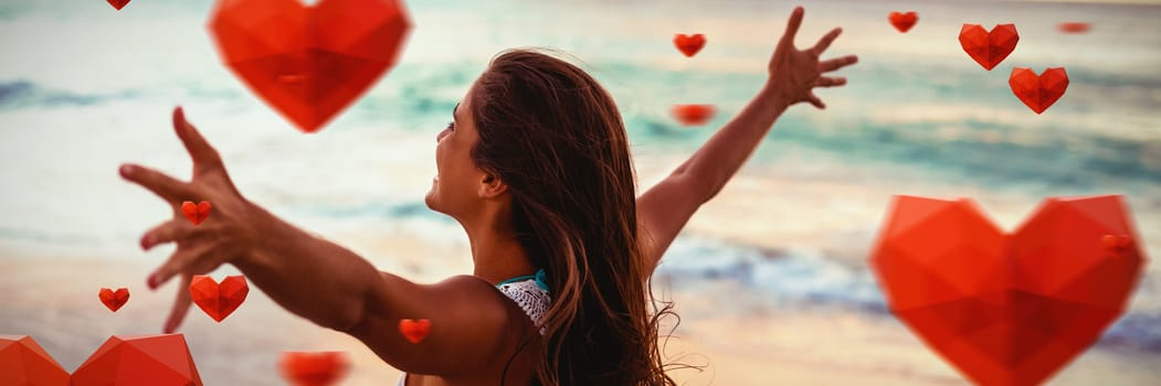 Red heart with white blackground against side view of woman stretching out her arms