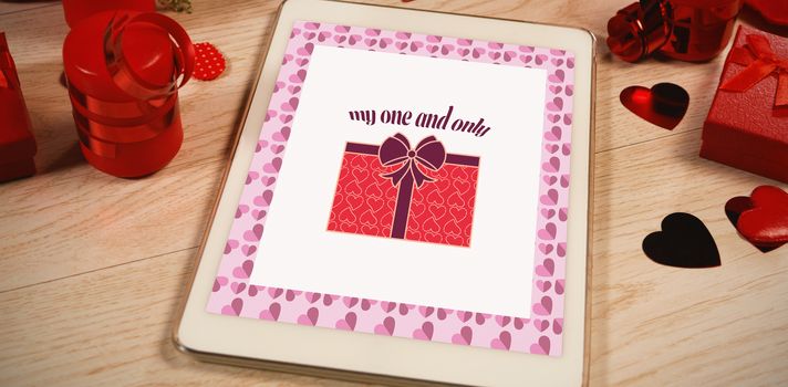 Cute Valentines Day message in Frame on desk with gifts and petals