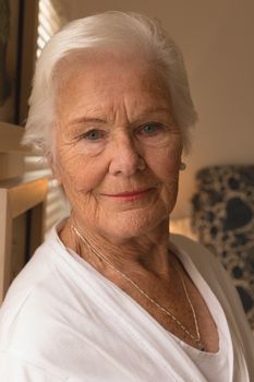 Portrait of happy senior woman smiling while looking at the goal in bedroom at home