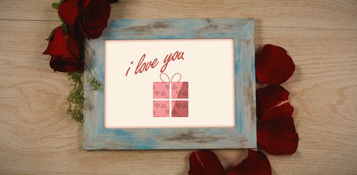 Cute Valentines Day message in Frame on desk with gifts and petals