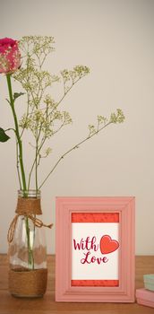 Cute Valentines Day message in Frame on desk with gifts and petals