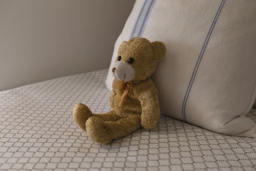 Close-up of teddy bear on a bed in bedroom at home
