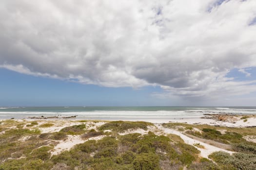 Wide shot of beautiful and calm beach on a cloudy day