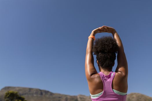 Low angle view of  African American woman performing yoga in the backyard of home on a sunny day