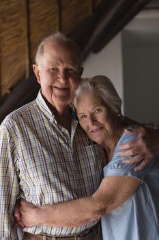 Portrait of  an active senior couple standing and embracing each other at home