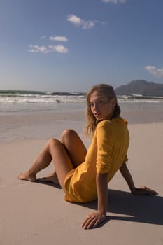 Portrait of young woman relaxing at beach on a sunny day