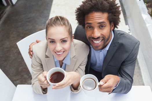 Happy business people on their lunch outside at the coffee shop