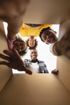 Upward view of happy African American family unpacking their belongings at home