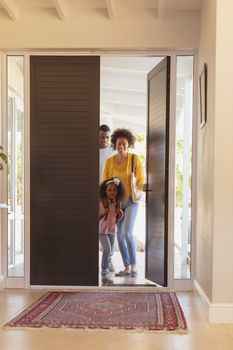 Front view of happy African American family returning sweet home