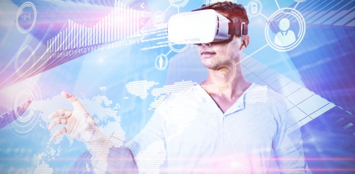 Man using virtual reality headset against composite image of technology interface