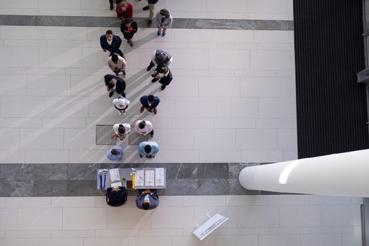 High angle view of multi-ethic group business people standing in queue at office