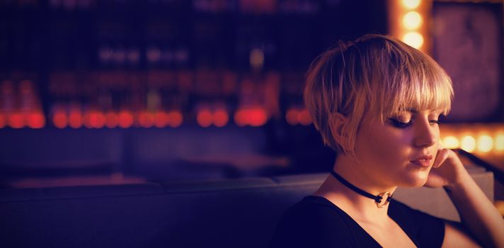 Beautiful woman sitting on a couch in bar