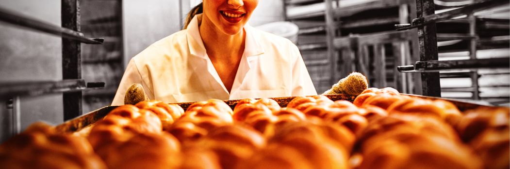 Female baker working in bakery shop