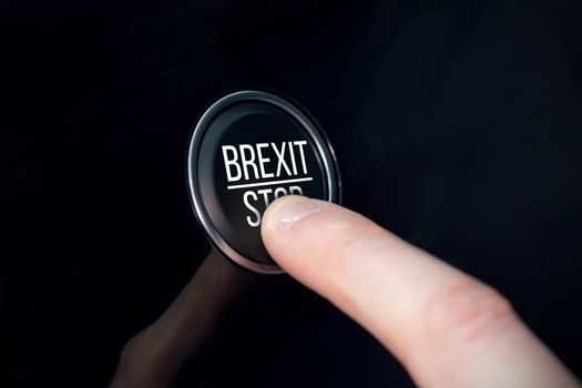 Brexit stop in capital letter against finger pressing a button