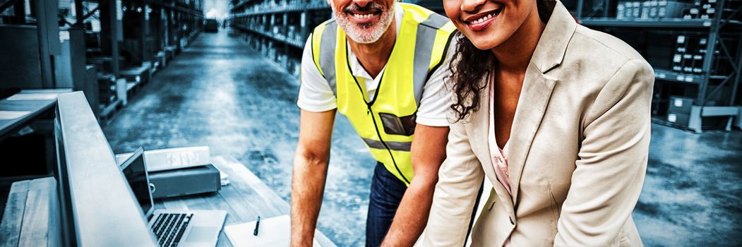 Portrait of warehouse manager and worker working together in warehouse office