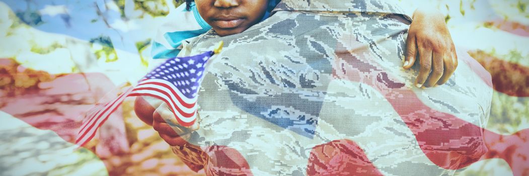 Close-up of wrinkled American flag against happy family posing together