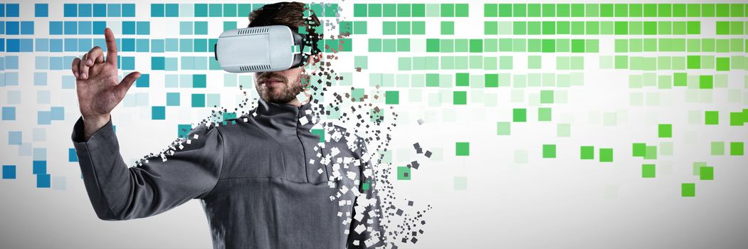 Man gesturing while using virtual reality headset against blue and green squares