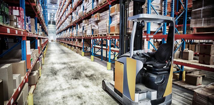 View of pallet truck and goods tidy in a warehouse