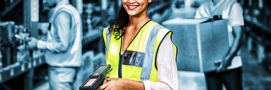 Portrait of female warehouse worker standing with barcode scanner in warehouse