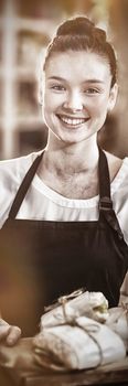 Portrait of smiling waitress holding a tray with sandwiches in cafe