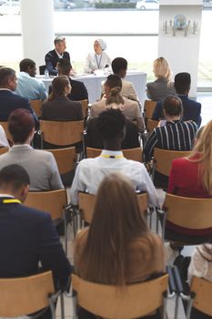 Rear view of group of diverse business people waiting while attending a business seminar in office building