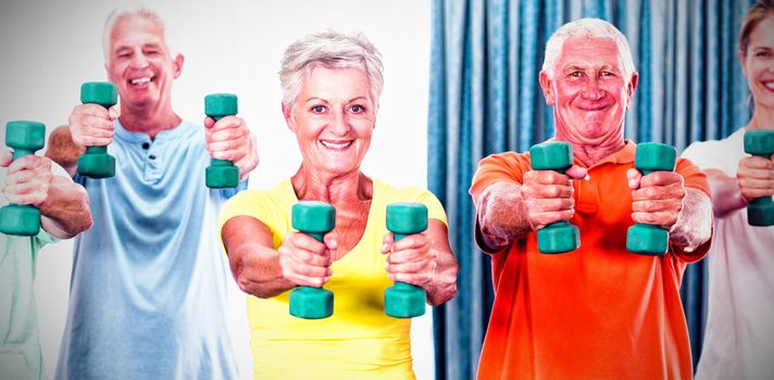 Portrait of seniors exercising with weights during sports class